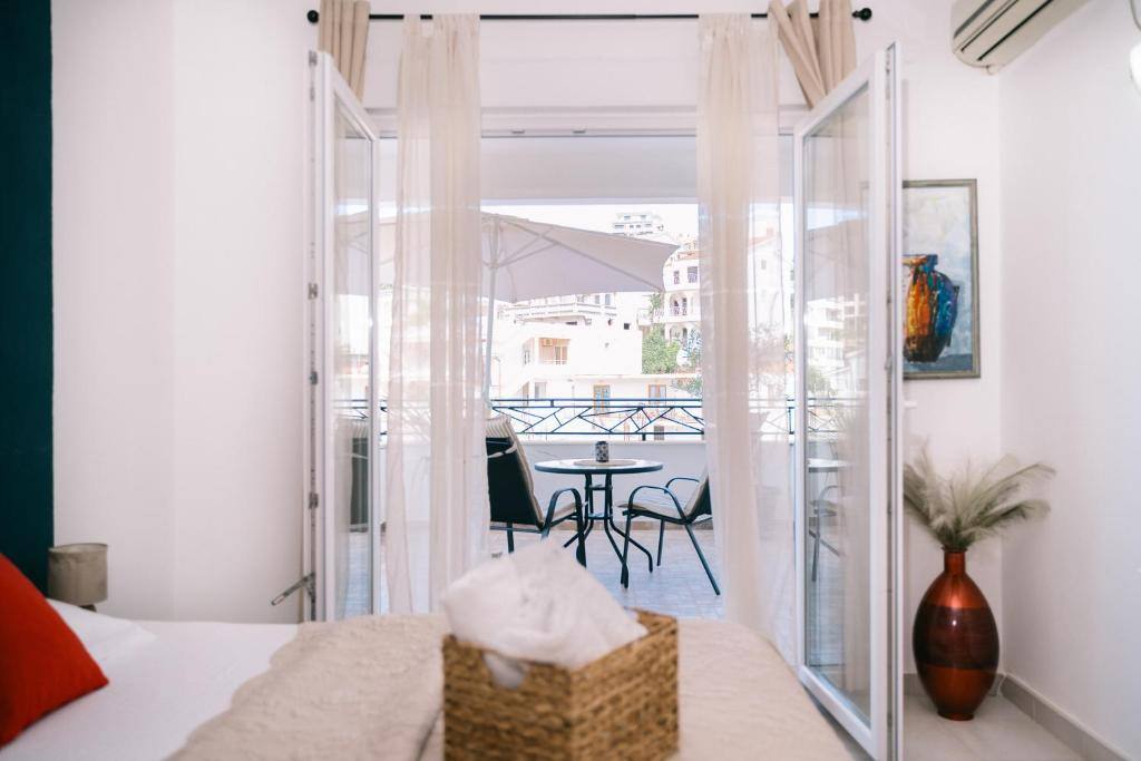 Studio doorway opening onto a private balcony with table and chairs in Ulcinj